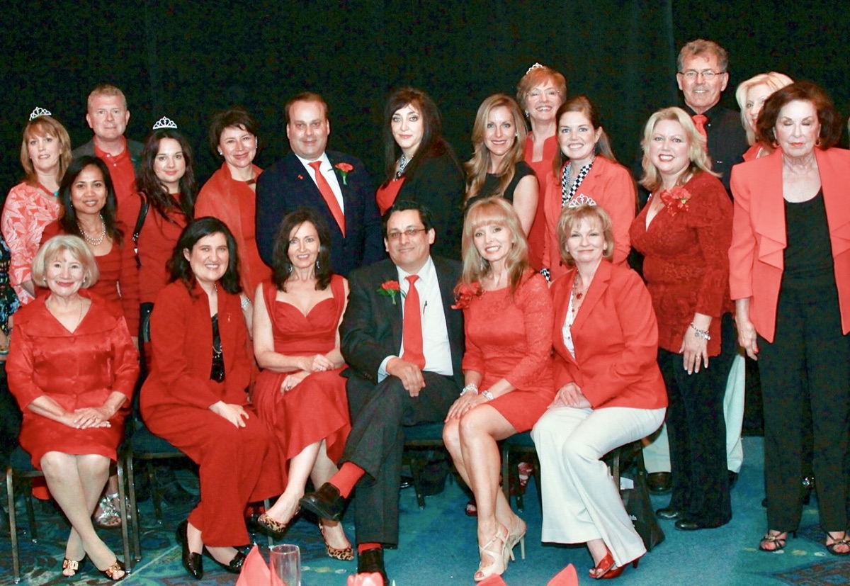Santiago Mendoza, Jr. with fellow volunteers dressed in red at an American Heart Association Go Red for Women event