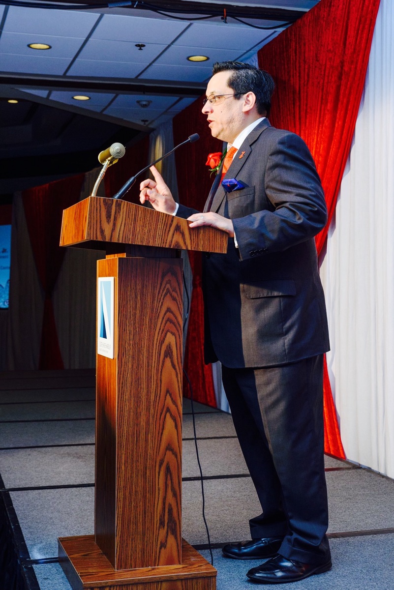 Santiago Mendoza, Jr. addressing an audience from a podium
